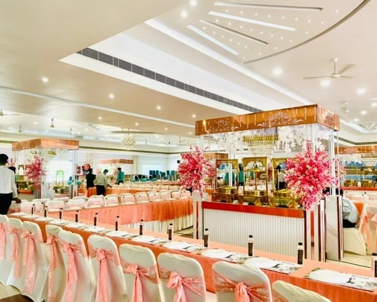Elegant banquet hall with peach & pink decor.