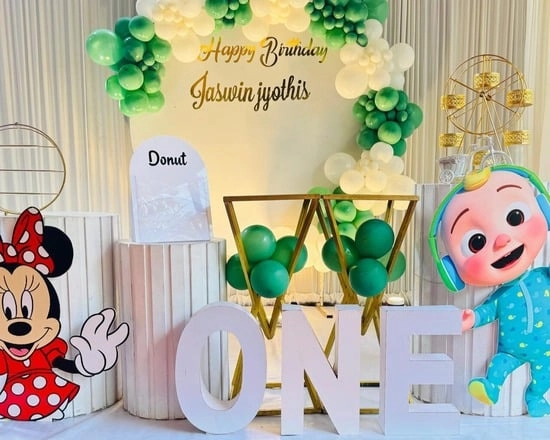 Kid's birthday setup with balloons & cutouts.